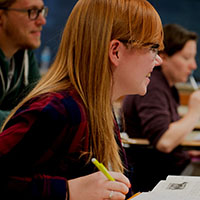 A student smiles while participating in a class.