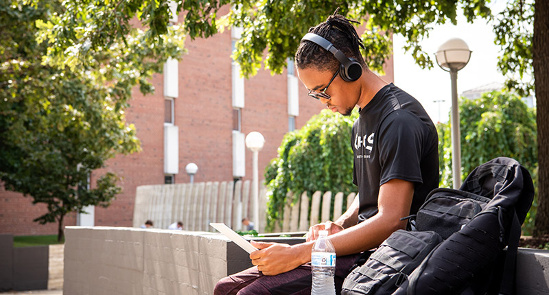 Student sitting at a desk with a laptop.