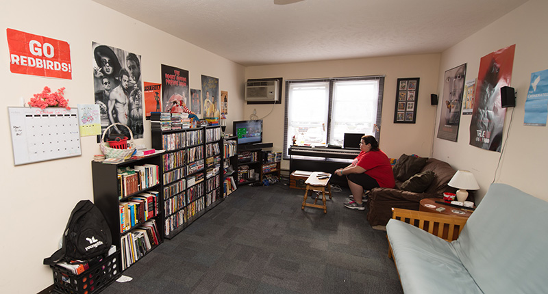 Student playing video games in the living room of their apartment.